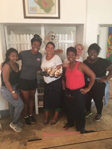 Michaela Tummings '17 stands with a few friends in the study abroad class along with the owner and staff of the restaurant Tastebud in Stellenbosch, South Africa