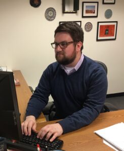 Jeffrey Zimmer '10 works on his desktop computer at the office