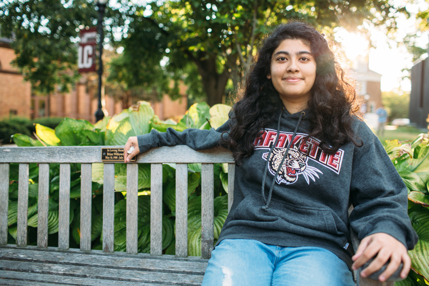 Aleeza Ajmal '18 sits on a bench on the Lafayette College campus