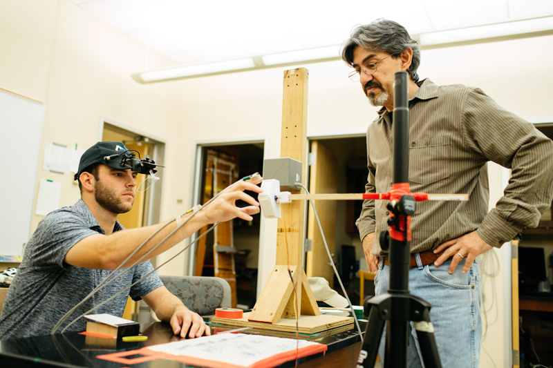 Matthew Barrett '17 and Professor Luis Schettino conduct motion research in a lab.