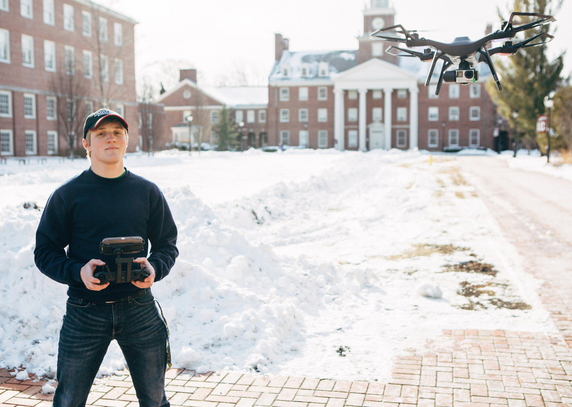 Travis Shoemaker '18 uses a remote control for a drone.