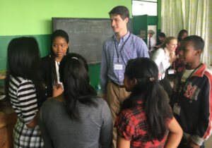 Malagasy students and Lafayette student mentors talk in a group.